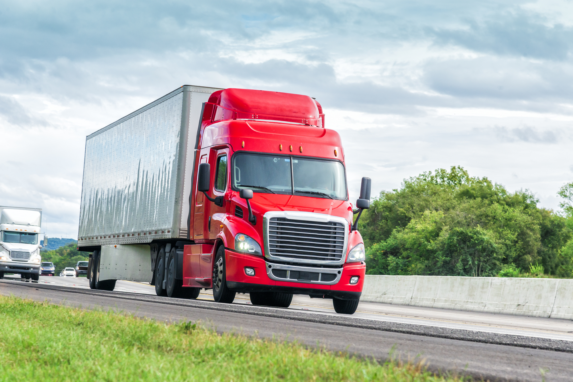 Common Questions After A Truck Accident - Red Eighteen Wheeler Travels Interstate Highway
